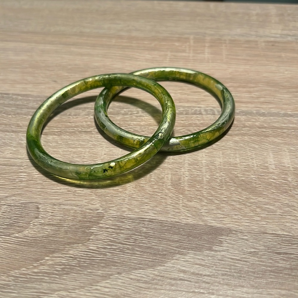 Two bright green bracelets with silver details